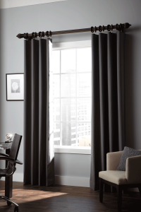 Dark drapes hanging over a window, pulled to each side 