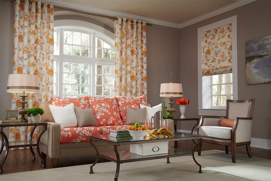 Floral draperies matching an orange floral sofa