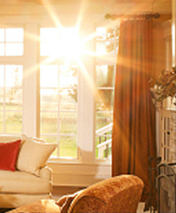 Sunlight shining directly through a window into a living room, illuminating the whole space