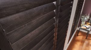 Details shot of rich, dark louvers of real wood shutters