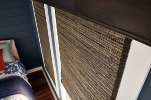 Woven blinds in earthy color with dark brown headrail