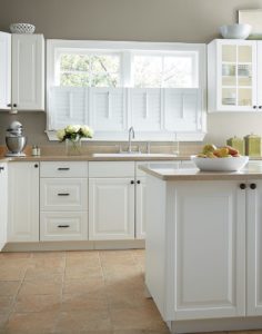 Tasteful kitchen with brown-and-white color scheme and demi-shutters over the kitchen sink